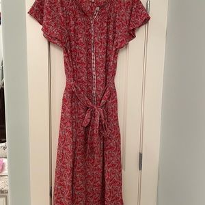 Red dress with small white flowers. Ruffle short sleeves.Buttons to waist.